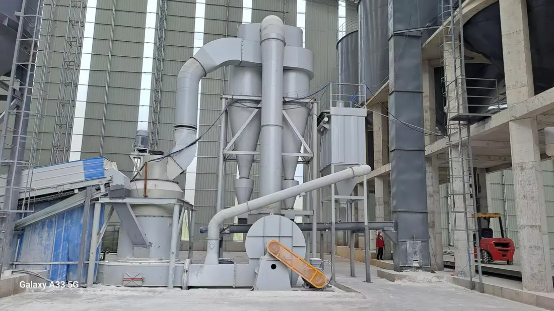 Indoor coal grinding mill installation showing main unit, classifier and process piping