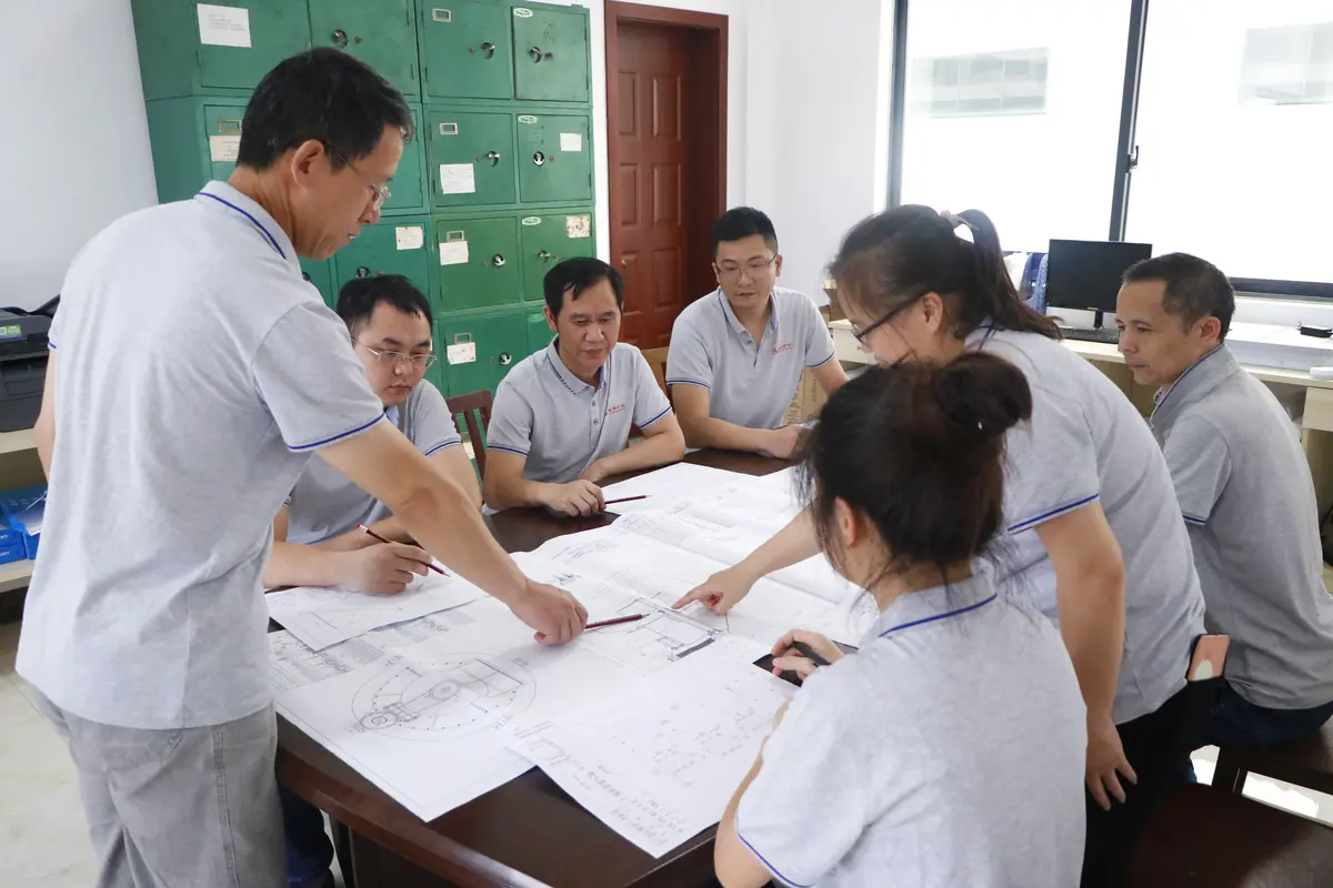 Cronus engineering team reviewing grinding mill drawings and process calculations